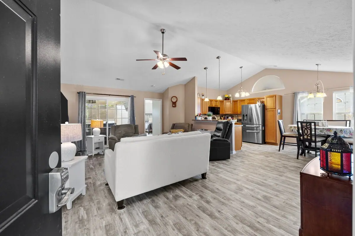 Open living room and kitchen with white sofa and dining area