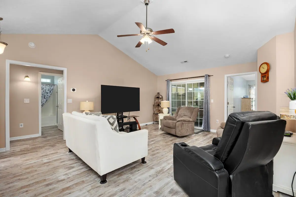 Living room seen toward glass doors and adjoining room