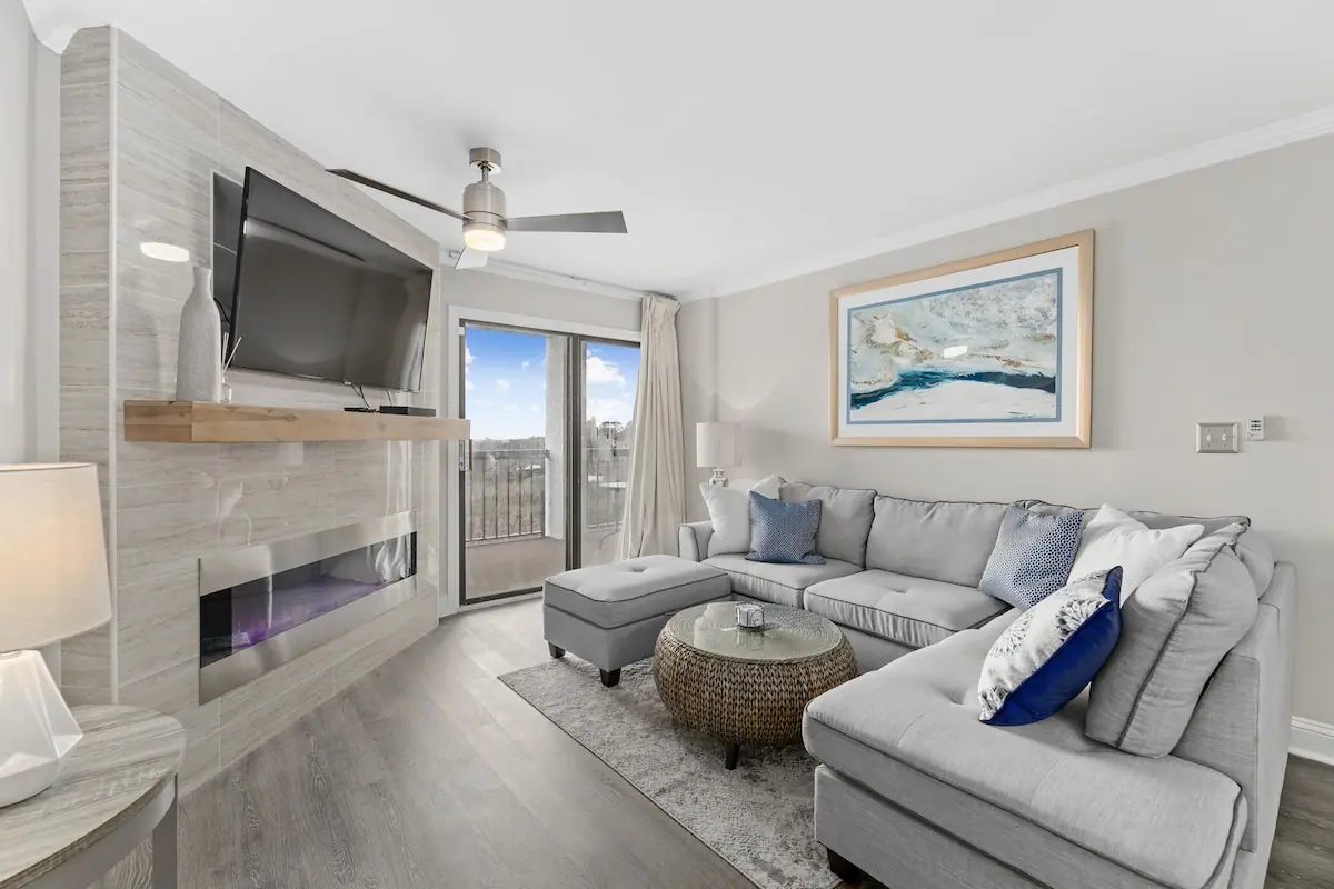 Gray sectional sofa facing television above a fireplace