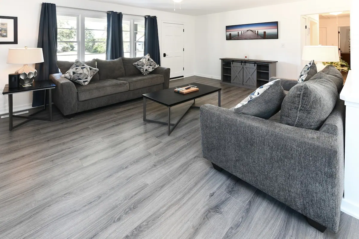Living room with two gray sofas, coffee table, and a window