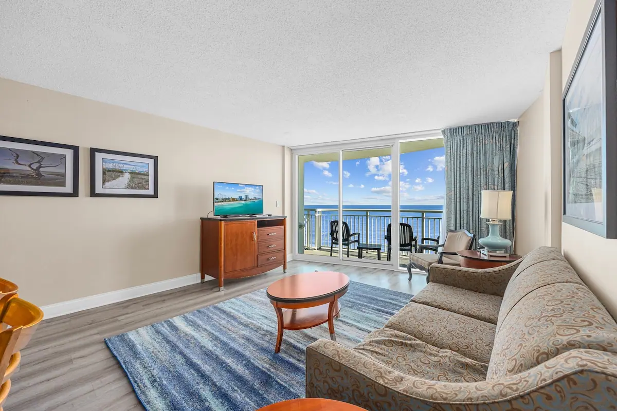 Patterned sofa in a living room with glass doors to the ocean-facing balcony