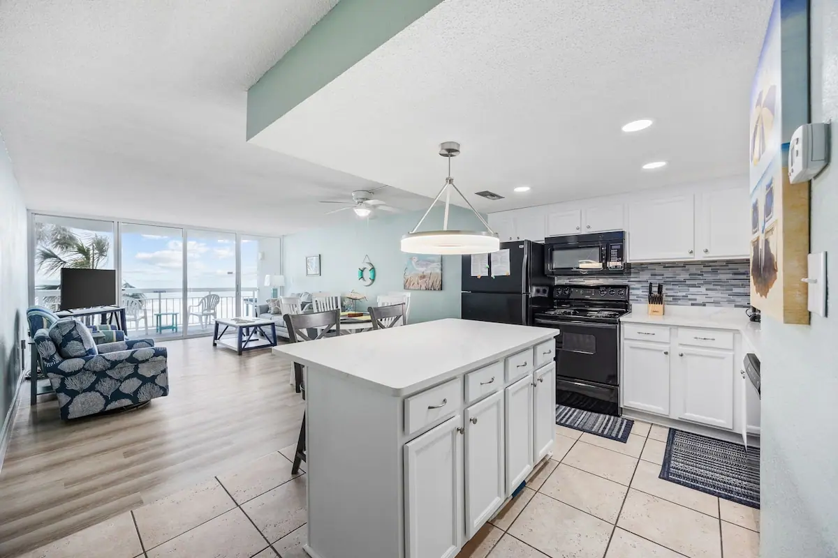 Kitchen island looking toward the living room and ocean-facing glass doors