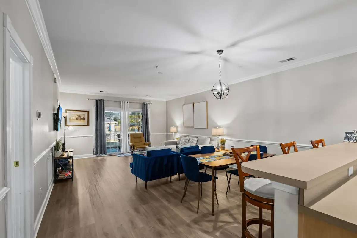 Open kitchen counter, dining area, and blue living room