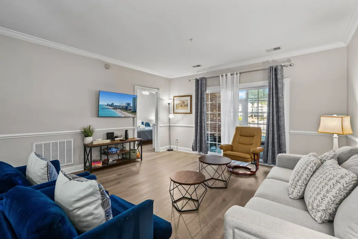 Blue armchairs and white couch in a bright living room